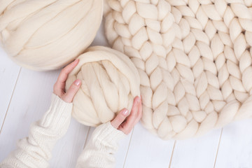 a ball of thick yarn and a blanket of thick wool