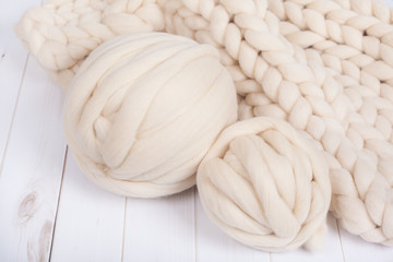 a ball of thick yarn and a blanket of thick wool