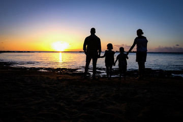 Fototapeta na wymiar Family watching the sunset