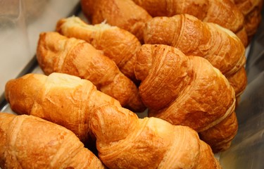 fresh French croissants on the bread shop counter close-up