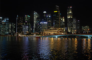 Fototapeta na wymiar Modern architecture around Marina Bay in Singapore city centre illuminated at night
