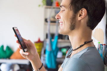 Young man using smartphone at home