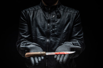 Serial killer maniac holding knife on his hands with gloves / killer tools
