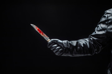 Serial killer's hand with bloody knife