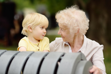 Beautiful granny and her little grandchild together in park