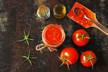 Homemade fresh tomato sauce in a jar. Tomatoes and spices.