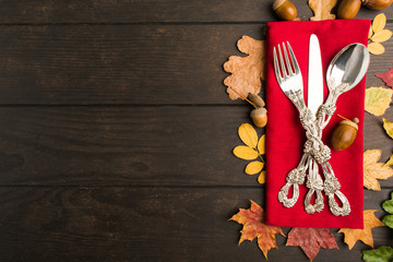 Autumn thanksgiving table with tableware and red napkin