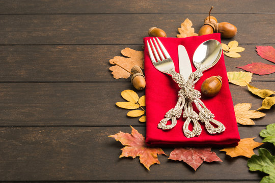 Autumn thanksgiving table with tableware and red tissue
