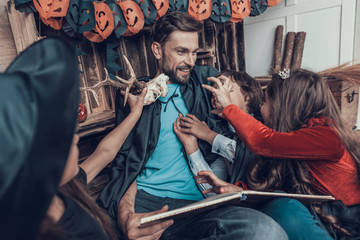 Man and Children in Halloween Costumes having Fun