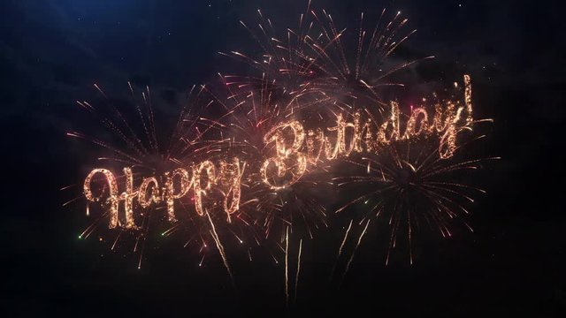 Happy birthday celebration greeting text with particles and sparks on black night sky with colored slow motion fireworks on background, beautiful typography magic design.