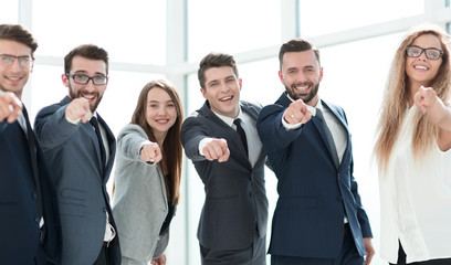 happy business team pointing at you.