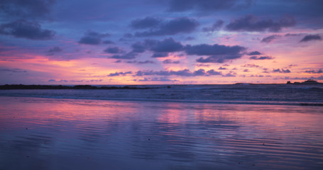 Fototapeta na wymiar Out of focus background plate of remarkable purple and blue sunset on the beach