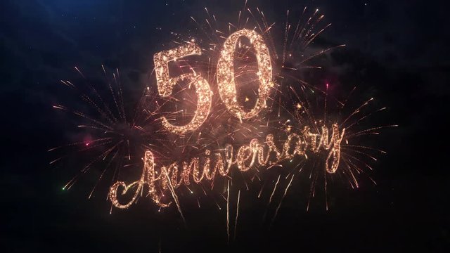 Happy birthday Anniversary 50 years celebration greeting text with particles and sparks on black night sky with colored slow motion fireworks on background, beautiful typography magic design.