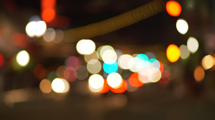 Background plate of city traffic at night with bokeh headlights passing by