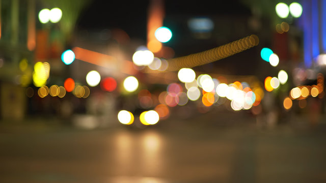 Background plate of city traffic at night with bokeh headlights on street
