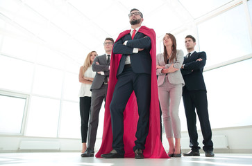 leader in the red cloak and the business team standing together