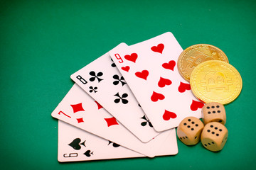 poker game objects - game cards, dice and bitcoins on a green background