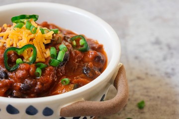 Homemade Black beans Beef Chili topped with cheddar cheese and green onions