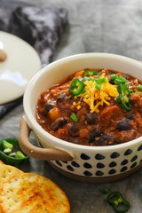 Homemade Black beans Beef Chili topped with cheddar cheese and green onions