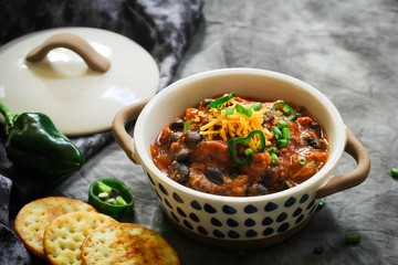 Homemade Black beans Beef Chili topped with cheddar cheese and green onions