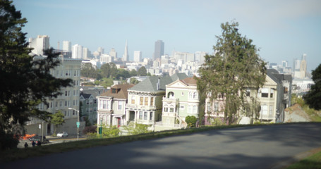 Fototapeta na wymiar Exterior shot of Victorian row house against urban skyline