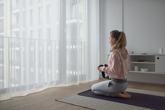 Woman with vr equipment preparing for yoga session