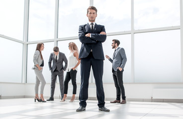 bottom view.confident businessman standing in spacious lobby