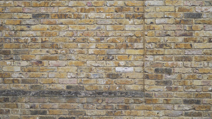 Background of weathered yellow and grey brick wall in Windsor England