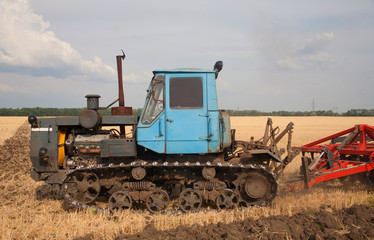 Fototapeta premium Tractor preparing land for sowing