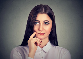 Pensive young woman in doubts