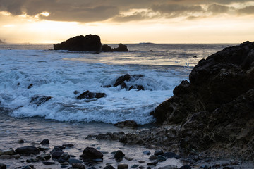 Fototapeta na wymiar Pacific Ocean Washing over the Rocks at the Coast