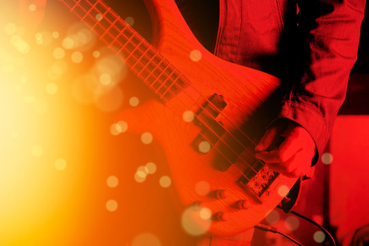 Life style image of close up young man hand, playing electric bass guitar