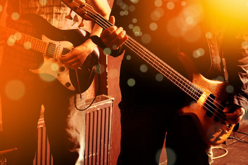 Obraz premium Life style image of close up two young male guitarists hand, playing electric guitar