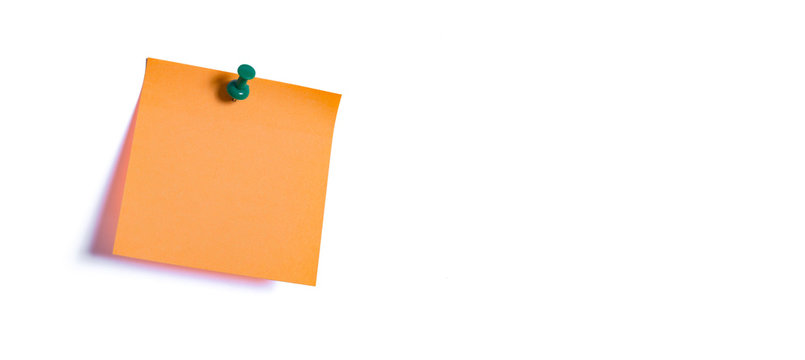 orange note paper fastened to the wall