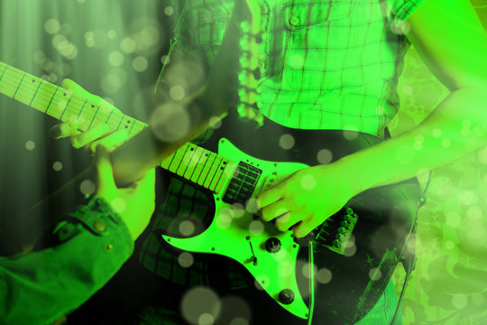 Life style image of close up young male guitarist hand, playing electric guitar