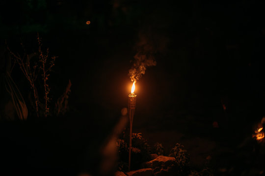 Burning Tiki Torch At Night