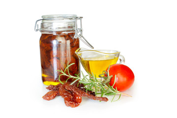 Sun dried tomatoes in olive oil in a jar isolated on white background