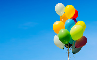 Colorful bunch of helium balloons isolated on background