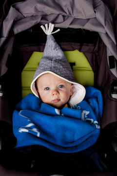 baby all bundled up in a stroller during the winter