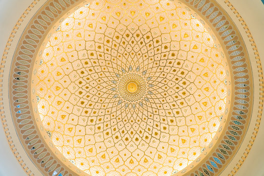 Looking up at the ceiling of a dome in a traditional Islamic building