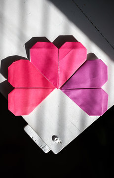 Origami hearts sitting on the corner of a desk