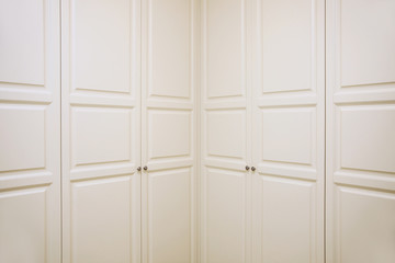 Huge closet in the wall, color beige with double doors