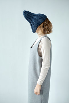 Woman with hat on face