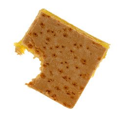 Top view of a freshly baked lemon square with one bite missing isolated on a white background.