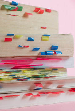 Stack of books with many bookmarks
