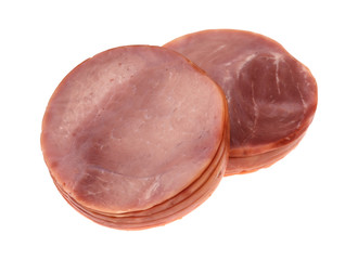 Side view of two stacks of round breakfast ham slices isolated on a white background.