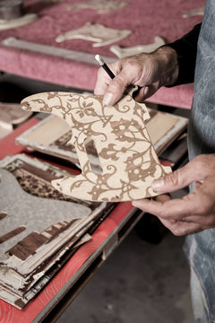 Young guitar luthier working in his workshop