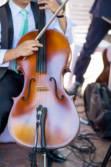 Classical music professional cello player solo performance, hands close up, unrecognizable person.Cello player or cellist performing in an orchestra isolated with copy space for background.