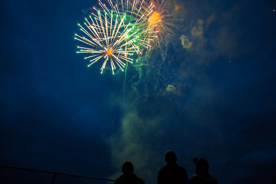 Fireworks celebration at night with friends watching