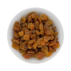 Top view of a small bowl filled with golden raisins isolated on a white background.